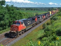 Canadian National Dash 9-44CW 2656, SD70M-2 8924 and Dash 8-40CW 2154 (ex-BNSF 838, nee-ATSF 838) are providing 12,700-horsepower of muscle for train Q 14921.  This intermodal train, passing through Newtonville, Ontario, is heading from Montréal, Québec, to Chicago, Illinois.  (August 25, 2019)