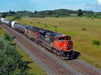 Not far from the shore of Lake Ontario, Canadian National train M37631 passes through bucolic Newtonville, Ontario, on a beautiful late summer day.  Powered by CN SD70M-2 8865 and Dash 8-40CM 2419 (with mid-train unit Dash 8-40CW 2125 [the former Union Pacific 9090, originally Chicago & North Western 8549]), train 376 is heading from Toronto, Ontario's MacMillan Yard to Rivière-des-Prairies, Québec, with a load of merchandise.  (August 25, 2019)