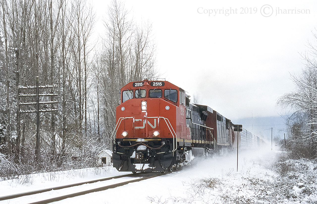 CN 2515, built in December of 1994, is just over a year old in this photo ... and with paint still intact. The 2405 is trailing as they roll through Rosedale on CN's Yale Sub.
