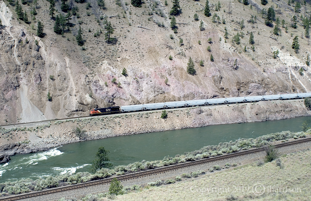 CN 3819 is westbound as it follows the Thompson River at Seddall on CN's Ashcroft Sub. Taken from across the river on CP's Thompson Sub and about half way between Spences Bridge and Lytton. GPS is approximate.