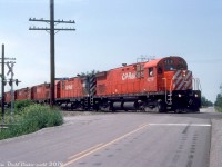 Leaving the <a href=http://www.railpictures.ca/?attachment_id=38098><b>climb out of the Welland Canal</b></a> behind, the five CP C424 "Centuries" from before motor over the double crossing at Crowland Ave. and Biggar Rd. on the former Conrail CASO Sub (that had become CP's Hamilton Sub) as they near Montrose Yard in Niagara Falls with an acid extra. This slide was stamped as the next sequential number after the previous shot at Brookfield, so Reg probably gave chase and managed to get ahead of it here before it arrived at the yard. <br><br> Incidentally, <a href=http://www.railpictures.ca/?attachment_id=34530><b>this photo</b></a> by Bill Thomson was taken at the same crossing on the CASO early in the Conrail era, but the train is heading in the opposite direction (having departed Montrose Yard). <br><br> <i>Reg Button photo, Dan Dell'Unto collection slide.</i>