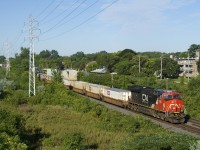 East of Montreal CN 120 is generally 3+1 for power, but from Toronto to Montreal it's generally just 1+1 or 2 units up front. Here CN 120 is still west of Taschereau Yard (where it will add more power and more platforms) with CN 3165 up front and CN 3048 mid-train.