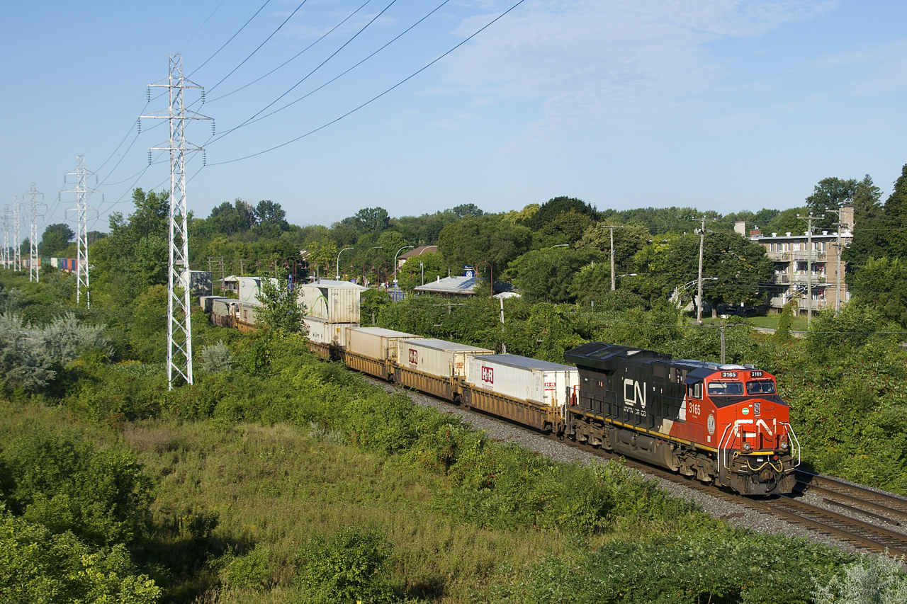 East of Montreal CN 120 is generally 3+1 for power, but from Toronto to Montreal it's generally just 1+1 or 2 units up front. Here CN 120 is still west of Taschereau Yard (where it will add more power and more platforms) with CN 3165 up front and CN 3048 mid-train.