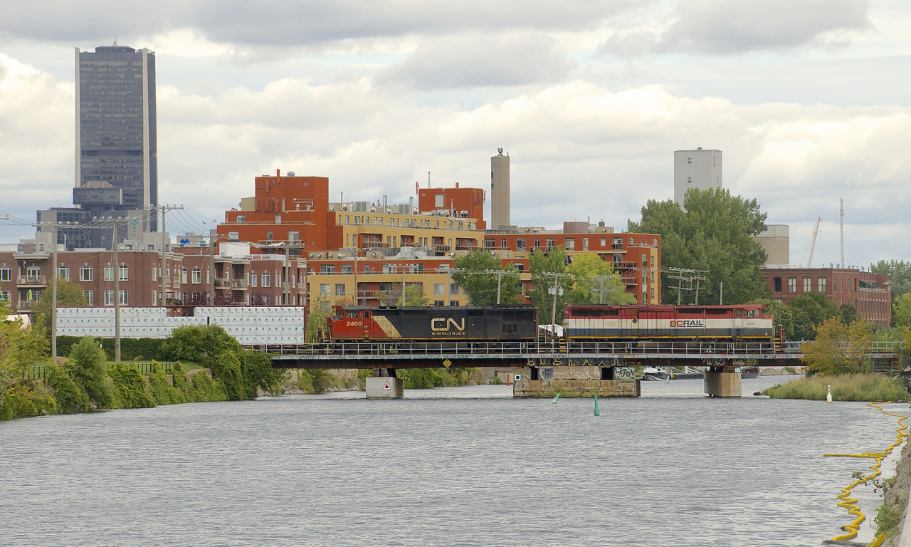 A pair of cowls (BCOL 4624 and class leader CN 2400) lead a 72-car CN 324 over the Lachine Canal. It is heading to St. Albans, Vermont and interchange with the NECR.