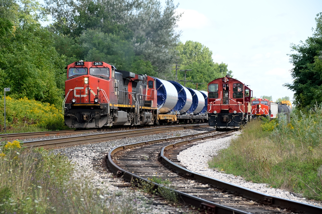 Triple Meet! OSR sits on the interchange waiting for CN 397 to complete its lift and setoff while CN 307 passes by with its train of Windmill Towers.