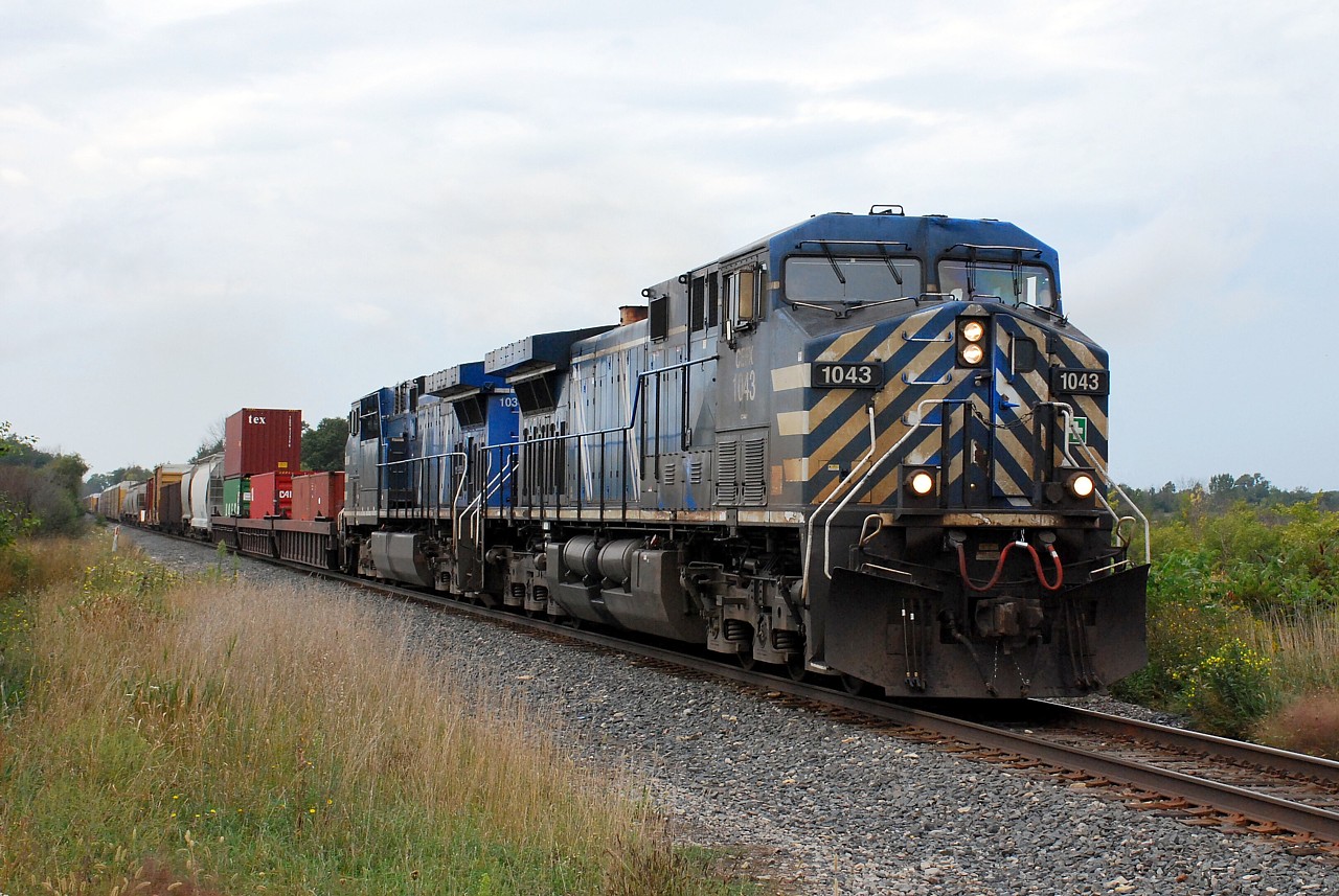 In desperate need of a bath, two grubby CEFX AC4400CWs lead CP 246 southbound on the Hamilton Sub. having just conquered the Niagara Escarpment.