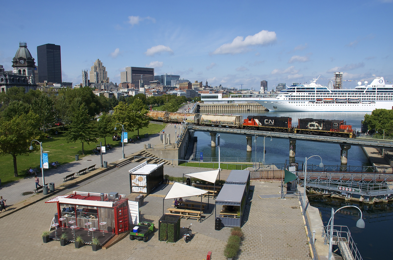 With the cruise ship Insignia in the background, a short transfer is leaving the Port of Montreal with CN 7229 & CN 4700 for power.