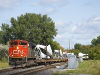 CN X325 rounds a curve in St-Henri with CN 8940 and a unit train of windmill blades. The blades are built by LM Wind Power Canada in Gaspé, Quebec and are on their way to Norfolk, Nebraska. Union Pacific will take the train over at West Chicago.