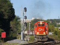 Trailing unit CN 2173 lets out a bit of smoke as a 64-car CN 324 rounds a curve in St-Henri with ex-Oakway SD60 CN 5431 leading.