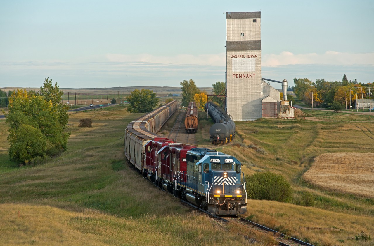 Great Sandhills Railway passes the elevator at Pennant with Canpotex cars bound for storage elsewhere on the line.
