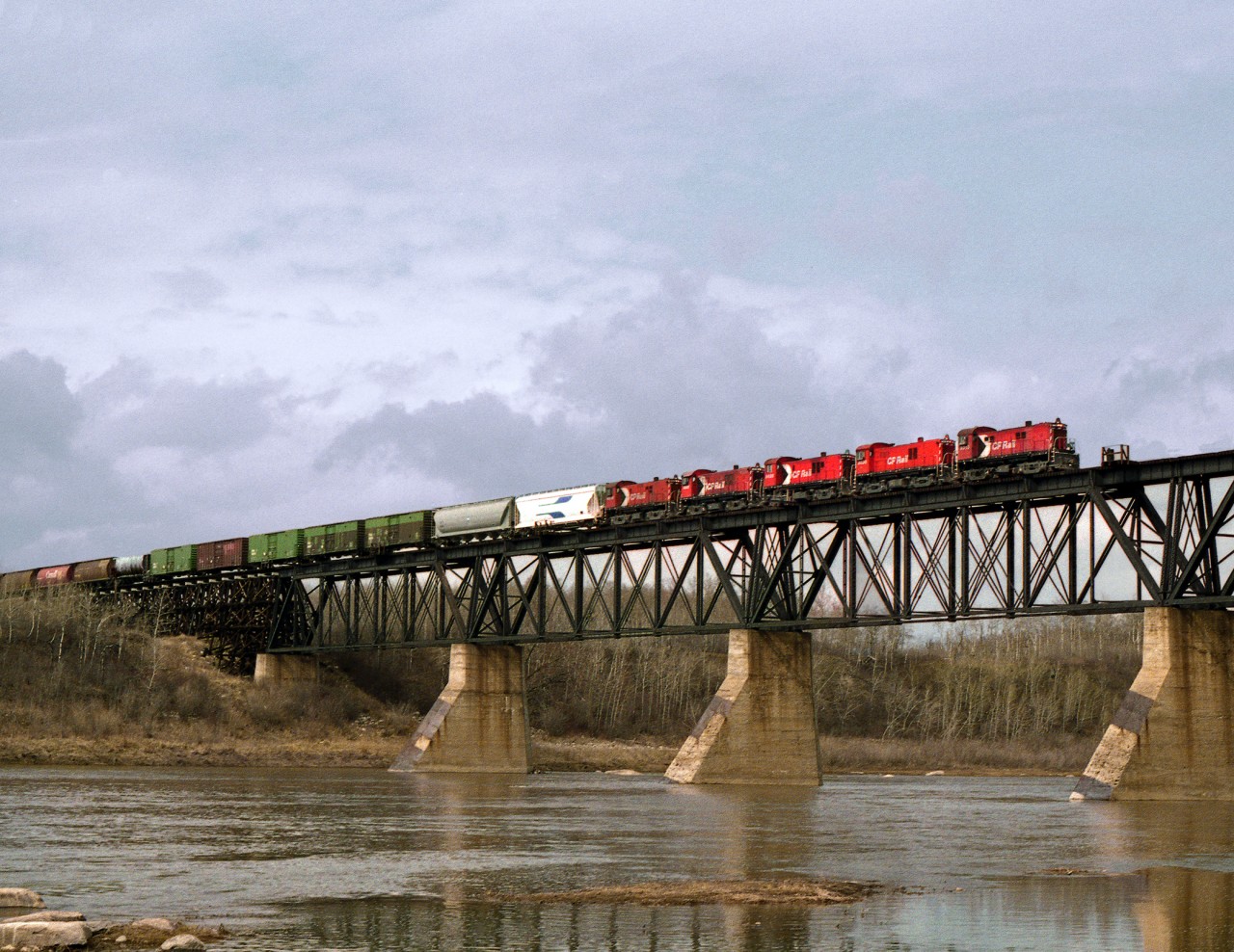 CP's daily Prince Albert to the North Main connection at Lanigan with 4 RS23's crosses the South Saskatchewan River on CN Running rights