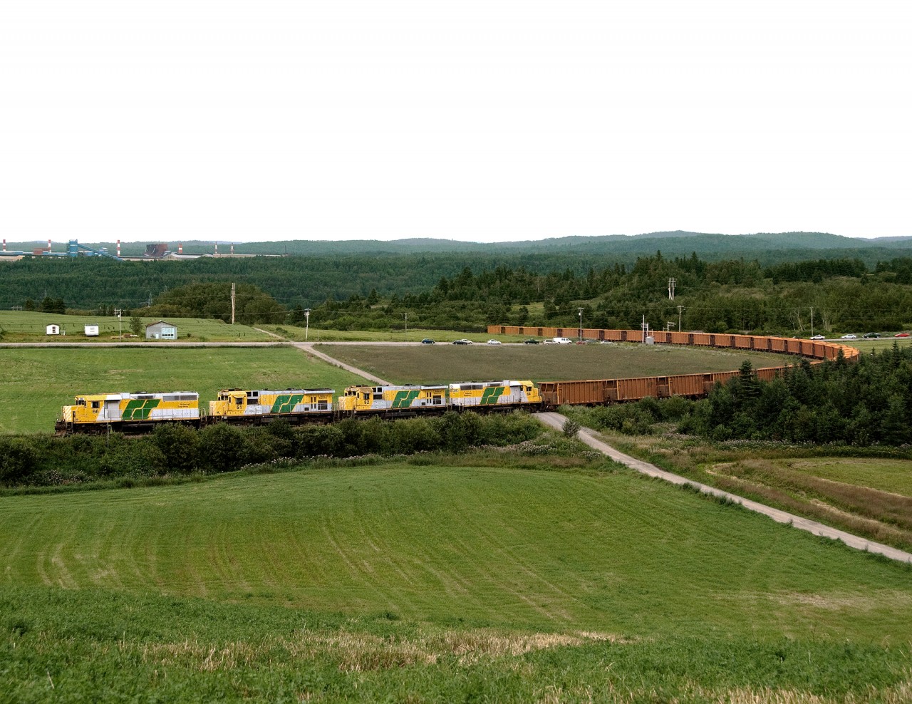 Bauxite ore train bound for the smelter at Arvida loops out of the harbour at La Baie on Ha Ha bay