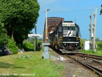 C93 lands on Canadian Soil with a pair of SD40-2's in the lead, thankfully (photographically speaking) this transfer often has good NS yard power instead of the dreaded GE monotony. The boys would take the CASO to drop off their train.
<br><br>
My daughter decided she wanted to have her Birthday party at Great Wolf Lodge in Niagara Falls this year and as my kids get older, I just leave and go watch trains instead of hang around all day turning into a prune in the wavepool.  Since Niagara falls has almost nothing to note train wise these days  I spent the morning in Buffalo to see some good US action then on the way home waited for C93 before going back to GWL for dinner plans. I looked forward to this trip all spring and was able to make the most of it. With luck I'll be back next year. This vantage point is easy as long as you ask for permission from the adjacent property owner, if around they were quite friendly and willing to give permission - it's the used car sales lot kitty corner to "Courtwright street".