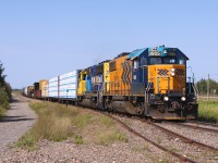 1805 and 2200 bring their train through Val Rita on a nice Autumn day in 2012.  I had followed them from Hearst, an easy chase with the low speed limits on the line.  Enroute to Kapuskasing they had stopped in Opasatika and then travelled down the Agrium Sub before returning and continuing on towards Kapuskasing.