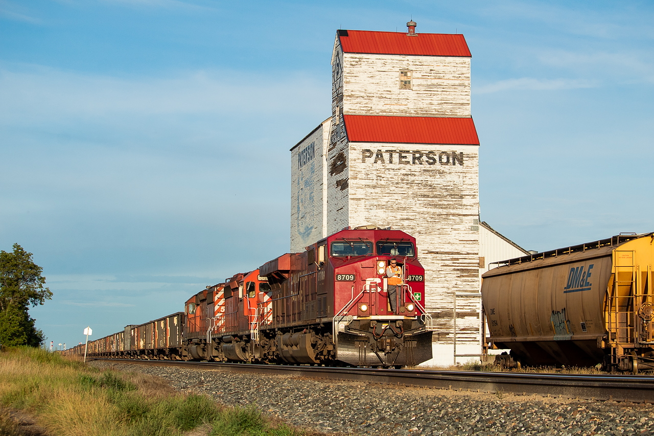 CP 851, 11,000 feet of coal empties from Thunder Bay to Sparwood, is pictured here heading past the old Paterson grain elevator and into the hole at Mortlach where it would have to wait for three eastbounds and one westbound to pass before proceeding onward. They blocked the 'main street' heading north-south in Town and the conductor waited at the crossing in case a car showed up, at which point they'd have to break the train. Once the four other trains cleared, he had to walk the thousands of feet back up to the head end so they could continue heading west. The DM&E hopper at right presumably got nailed by the detector and was set off there. There was a lone coal hopper sitting in the area too.