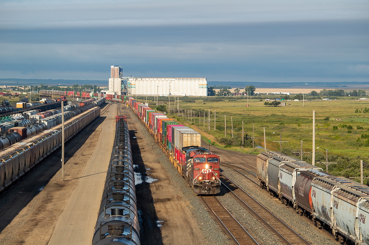 An early morning in Moose Jaw last month brought with it an interesting sky and a couple of eastbounds. Here, 8857 heads up 118 as it rolls into the yard in Moose Jaw. The large building in the background is Viterra, where I watched K39 pull 74 loaded grain hoppers out of later on that morning. A shot for another day perhaps. Moose Jaw is a pretty good hub of activity with a lot of trains coming in and out, and there is enough overall activity and noteworthy places nearby, interesting yard power, and interesting power at the shops to help compensate for the abundance of red GEs.