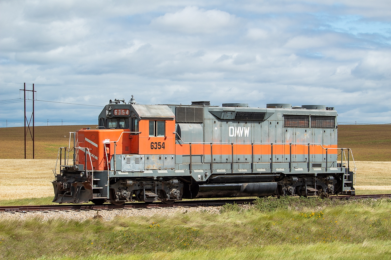 After chasing the GWR to Verwood I went down towards Coronach to see if the Poplar River Mine Railway was running. They were not unfortunately, though I was able to see the "new" unit GWR had left on them at the "interchange" (if you can call it that) near Coronach. This unit had formerly been at an elevator in Unity, Saskatchewan, but seemingly is going to replace or supplement one of the two SD40-2s on the Poplar River currently. Other RP contributors have shot the Poplar River in the past, such as Bill Hopper. It is an interesting and mostly captive operation, with them shuttling a small string of coal hoppers back and forth from the mine to the power plant, a distance of about a dozen miles with a relatively small loop track at both ends. Not much ever comes in or out of this operation from what I gather. Somewhat noteworthy as well was the number of the new K+S potash hoppers in storage nearby and throughout the GWR network overall. These hoppers had just recently rolled off the line at NSC in Hamilton.