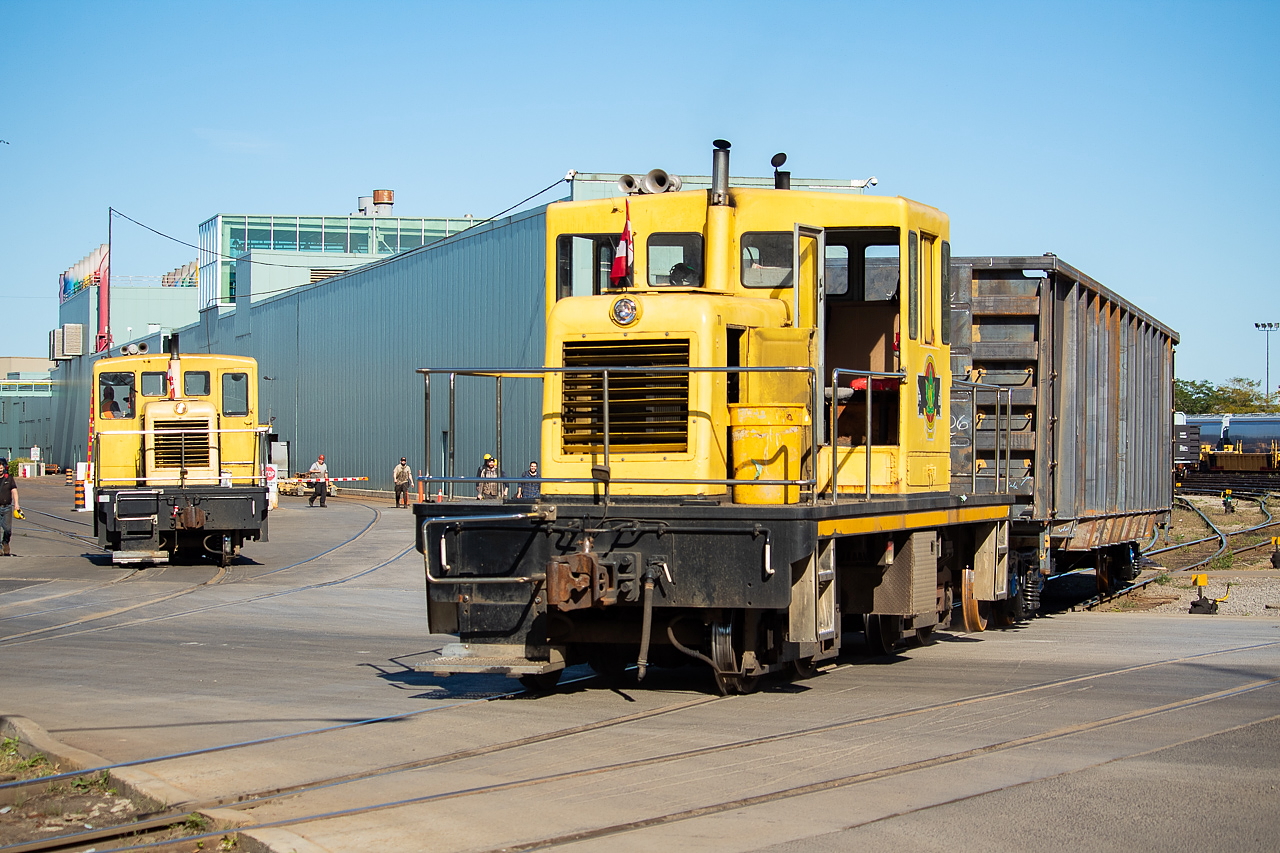 The shift may have changed, but the critters at NSC were still hard at work earlier this evening. The critter in the background at left was waiting to proceed back inward toward the plant. While the critter in the foreground was pulling this unpainted gon ahead to clear a switch and shove back into the building directly behind it, where paint (including the AIM logo) will be applied. AIM is getting an order of new gons filled by NSC, and I have to say they look quite sharp. The finished ones are black with AIM (in white) placed largely on the side.