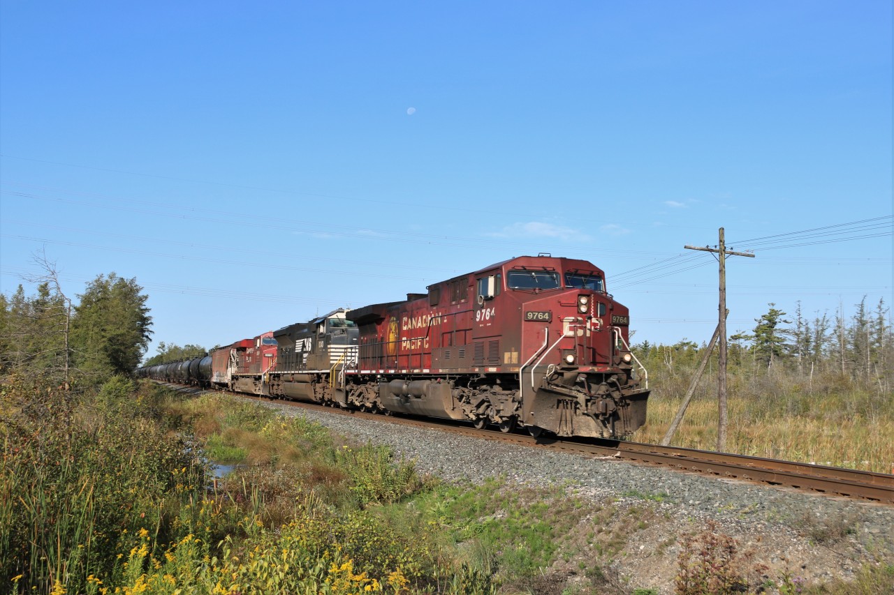 I was kind of expecting a late CP 234 but CP 650 showed up. Led by CP 9764 with NS 1040 and CP 8860 up front and CP 8610 pushing from the rear, the 432 total axle, 6390 foot train rumbles up to the 7th Concession headed east. Even the moon snuck in to the scene on this beautiful sunny morning.