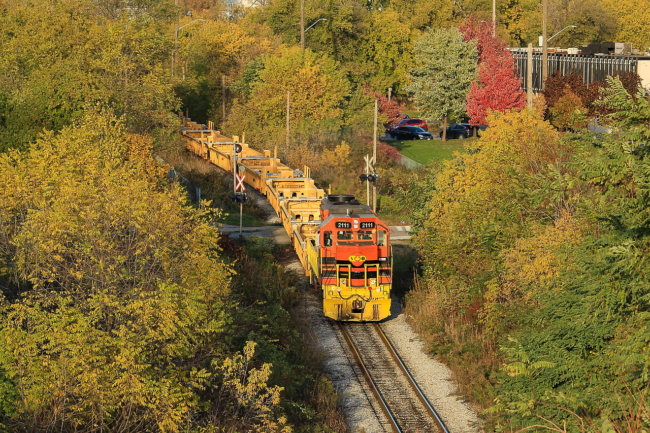 RLHH 2111 brings a string of new well cars from NSC out of the hole and into the yard.