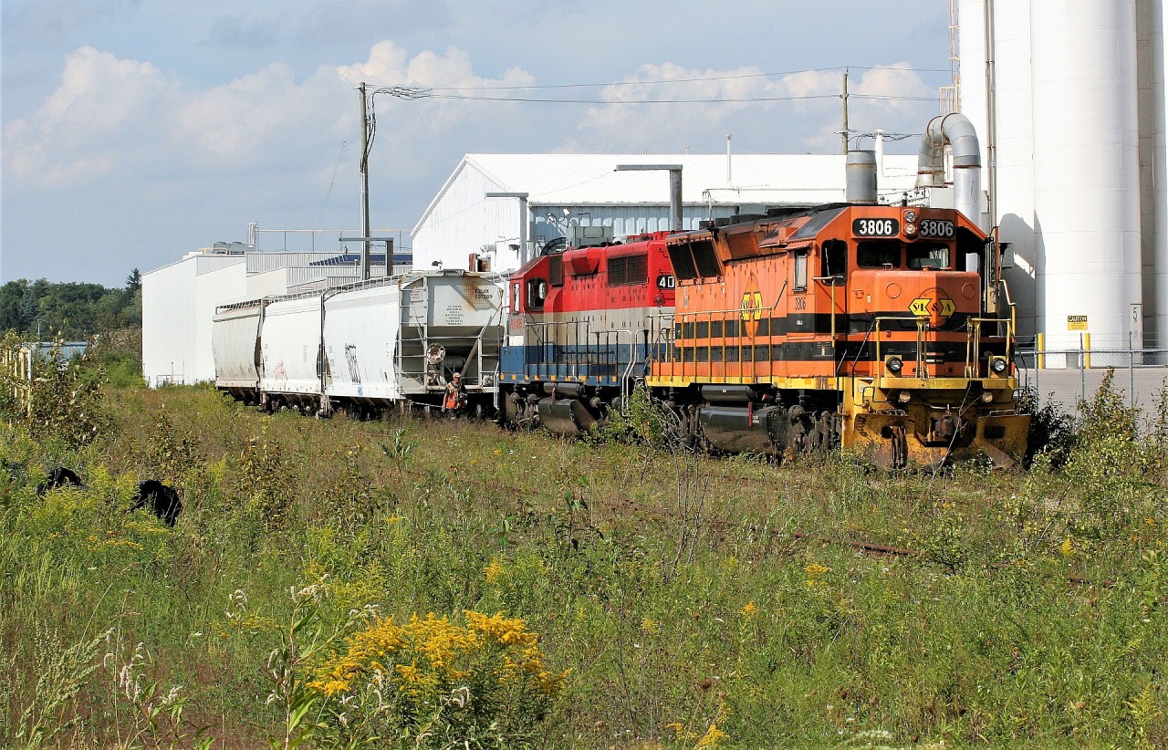 Goderich-Exeter Railway (GEXR) train 580 with SLR GP40-3 3806 and RLK GP40 4095 make a daylight appearance to switch the Ampacet Corporation Canada facility in Kitchener. This is currently the last active regular customer on the Huron Park Spur and is serviced as required. Convoy Supply, which is located on the spur as well did still receive a few cars this spring, however these are seasonal shingle carloads. Not far from the Ampacet facility, the Huron Park Spur had been taken out of service even though the rails are still in place to Manitou Drive. In recent years, the rusting former Budd Canada support yard tracks in the foreground have been utilized to store cars. Since the transition from GEXR to CN in November 2018, CN now once again services Ampacet Corporation Canada just as they did 20 years ago.