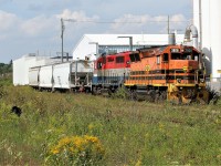 Goderich-Exeter Railway (GEXR) train 580 with SLR GP40-3 3806 and RLK GP40 4095 make a daylight appearance to switch the Ampacet Corporation Canada facility in Kitchener. This is currently the last active regular customer on the Huron Park Spur and is serviced as required. Convoy Supply, which is located on the spur as well did still receive a few cars this spring, however these are seasonal shingle carloads. Not far from the Ampacet facility, the Huron Park Spur had been taken out of service even though the rails are still in place to Manitou Drive. In recent years, the rusting former Budd Canada support yard tracks in the foreground have been utilized to store cars. Since the transition from GEXR to CN in November 2018, CN now once again services Ampacet Corporation Canada just as they did 20 years ago.