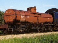 A recent post brought to mind this photo I took back in 1986. I think the time was around 20:00 on this evening when the Mixed train passed through Redwater. It was this car next to the coaches that sent me out to take pictures (besides the sun being out :-) ). On a few occasions, old cars like this were sent north to serve some purpose. I also noted on a couple of occasions, when returning home, some of these cars ended up at the car recycling facility, located just north of Edmonton on the Coronado Sub. I did check, not deeply extensive but looked, could not find any info for some history. The word FUEL is probably what the car was still being used for. Of interest, on the leading wheel, on the rear truck, the side of the wheel next to the axle can be seen. Looking carefully, you can see it has the curved fins to aid in cooling. Tonight's Muskeg Mixed consisted of 5585 and 5580 (GP38's) up front, behind tank 16025 is baggage cars 7855 and 7856 with coach 5099 and ex-NAR caboose 79101. Shot at mile 34. One last oddity, the flat car and tank 16025 both have upright brake wheels, don't see that to often anymore.