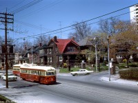 TTC PCC 4601 (an A10-class car originally built in 1940 for Cincinnati) heads eastbound through the High Park area on Bloor Street at Oakmount Road, passing a PCC heading the opposite direction while heading downgrade on the final stretch of the truncated Bloor route to Keele Subway Station. The new Bloor-Danforth subway line had been open for just a few months, and streetcars on Bloor had been cut back to two short segments at the west and east ends of the line known as the "Bloor Shuttle" and "Danforth Shuttle". New subway extensions opened at both ends of the line two years later in May 1968, rendered both remaining streetcar portions along Bloor redundant.
<br><br>
<a href=https://www.google.com/maps/@43.654247,-79.4621862,3a,75y,299.51h,90.18t/data=!3m7!1e1!3m5!1sccNoN2pkoB69x3WVJDWNKw!2e0!6s%2F%2Fgeo2.ggpht.com%2Fcbk%3Fpanoid%3DccNoN2pkoB69x3WVJDWNKw%26output%3Dthumbnail%26cb_client%3Dmaps_sv.tactile.gps%26thumb%3D2%26w%3D203%26h%3D100%26yaw%3D205.13449%26pitch%3D0%26thumbfov%3D100!7i16384!8i8192><b>Present-day</b></a>, the whole block of houses on this corner of Bloor and north into Oakmount and Pacific were bought up by developers and demolished 2011-2012 for high-rise condominiums. 4601 was likely one of the many older cars retired after the 1968 BD subway extensions rendered many of the older and secondhand PCC cars surplus (it wasn't one of the cars sold to Egypt however, so was likely scrapped or sold for scrap by the TTC).
<br><br>
<i>John F. Bromley photo, Dan Dell'Unto collection slide.</i>