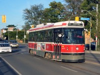Toronto Transit Commission CLRV 4011 heads west on the TTC's 506 Carlton line, passing through the intersection of Gerrard and Blackburn.  These Canadian Light Rail Vehicles were constructed by Bombardier-predecessor Urban Transportation Development Corporation (UTDC) from 1978 through 1981, and were unique to the city of Toronto, Ontario.  After nearly 40 years of service (beginning on September 30, 1979), the CLRVs will be retired by the end of 2019, replaced by more modern streetcars.  In the background is the Zhong Hua Men (中华门 or 中華門) Chinese Archway in the city's East Chinatown district.  The archway, which officially opened on September 12, 2009, was built to commemorate Canada's Chinese pioneers, labourers, railway workers and subsequent descendants and immigrants of Chinese descent who contributed to all aspects of Canadian society.  (August 30, 2019)