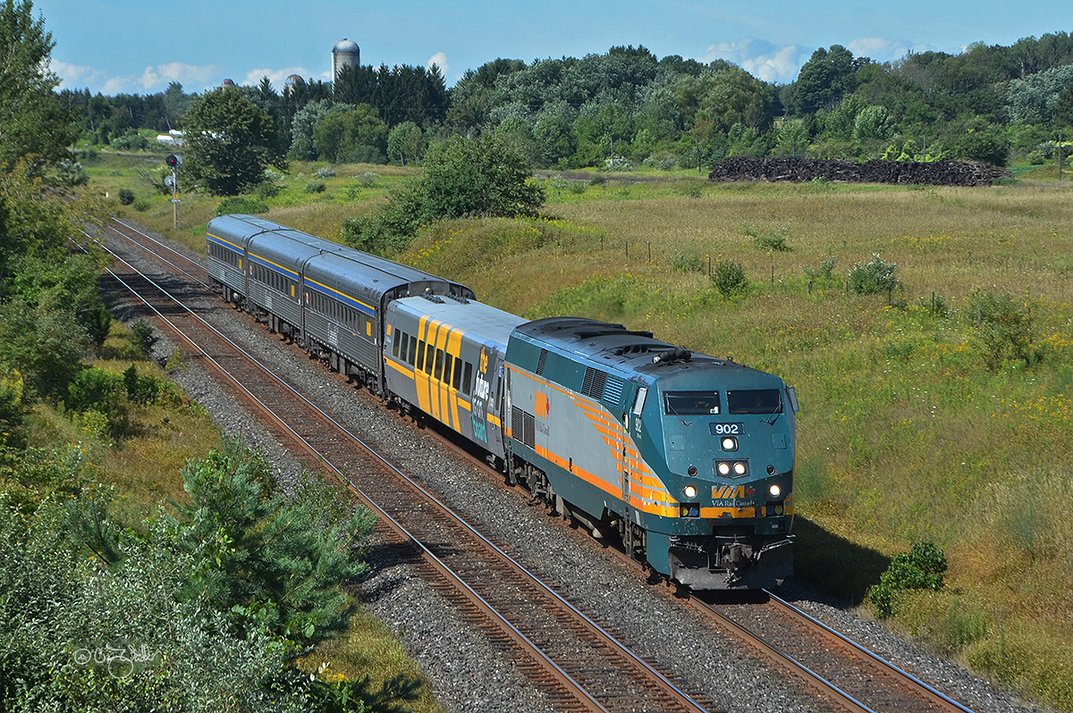 Whisking passengers between Toronto and Ottawa is VIA Rail Canada Corridor train 40.  VIA P42DC 902 (class EPA-42a) is pulling an LRC Business Class Car and three stainless steel coaches.  (Newtonville, Ontario - August 25, 2019)