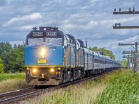 VIA Rail Canada train 2, the eastbound <i>Canadian</i>, speeds through Georgina, in Ontario's York District, on August 30, 2019.  This train originated in Vancouver, British Columbia, and has about 88 km (55 miles) left in its 4466 km (2775 miles), five-day and four-night journey to Toronto ON.  VIA F40PH-3s 6426 and 6435 are hustling their 21-car train at about 128 km/h (80 mph) as they click off the final miles of this longest passenger train route in Canada.