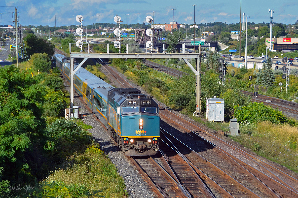 Rushing through Pickering Junction (in Pickering, Ontario), VIA Rail Canada train 52/62 heads east.  This combined Corridor train, comprised of F40PH-3 6439 and five LRC cars combined with F40PH-3 four more LRC cars, is heading from Toronto to Kingston, at which point the two trains will be separated with 52 continuing on to Ottawa and train 62 travels to Montréal.  Pickering Junction is where Canadian National's York Sub splits from CN's Kingston Sub.  (August 25, 2019)