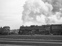 4-8-4 "Northern" CN 6247 appears to be working hard at low speed, with a crewman watching the front left from his cab window. <br>
The engine and train are about to pass MLW S-2 switcher CN 8133, class MS-10a built in 1949.<br>
CN 6247 was built by MLW in Sept 1943, CN class U-2-h. It was scrapped in July 1961.<br><br>

The negative data indicated location Danforth, presumably on the 3 km section of CN's Kingston sub that runs within 200 meters of Danforth Ave in Scarborough (Toronto).  CN Danforth is about 5 rail miles east of Toronto Union station, while GO Transit Danforth Station is at Main St.