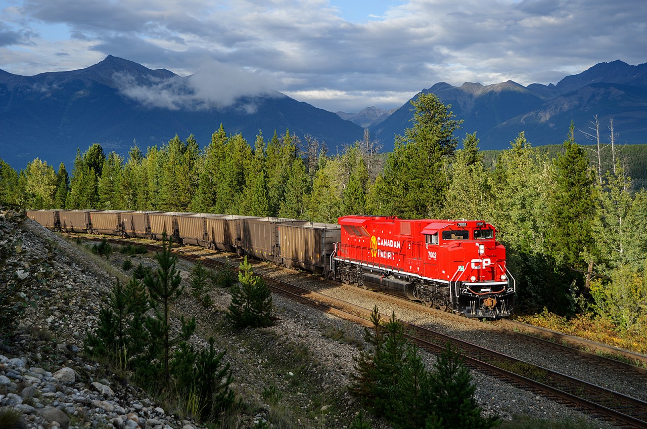 Brand new CP SD70ACU 7002 leads empty CN coal train C740 up the hill at Canoe River, heading back to home rails at Kamloops after dumping at Ridley Island in Prince Rupert a couple of days ago. This train is destined for re-loading at the Line Creek Mine near Sparwood, BC.