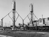 CP's Toronto Yard locomotive sand refill area more than 40 years ago, before it was modernized.<br>
SD40-2 CP 5678 is in position for filling the front sandbox, while M636 CP 4730 is nearby.<br>
In the background, left to right, are TH&B 77, CP 5731, CP 5537, with CP 4705 inside the diesel shop.<br>
The official name of the diesel shop as of 2019 appears to be Locomotive Reliability Centre, based on signage visible from Finch Ave bridge.