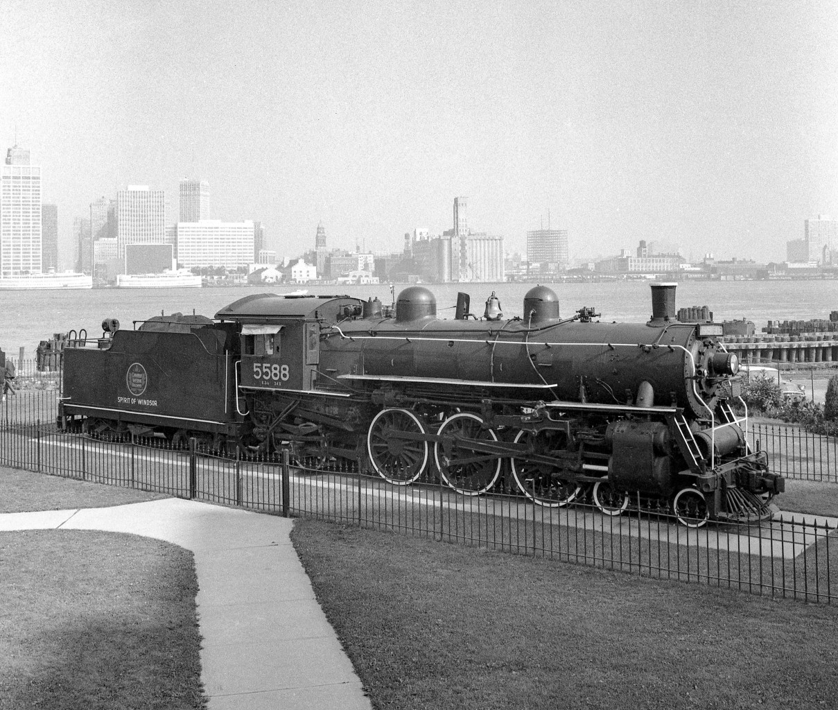 CN 5588 "Spirit of Windsor" sits in a park in Windsor, Ontario in the late 1960's/early 1970's. In the background is the Detroit skyline.