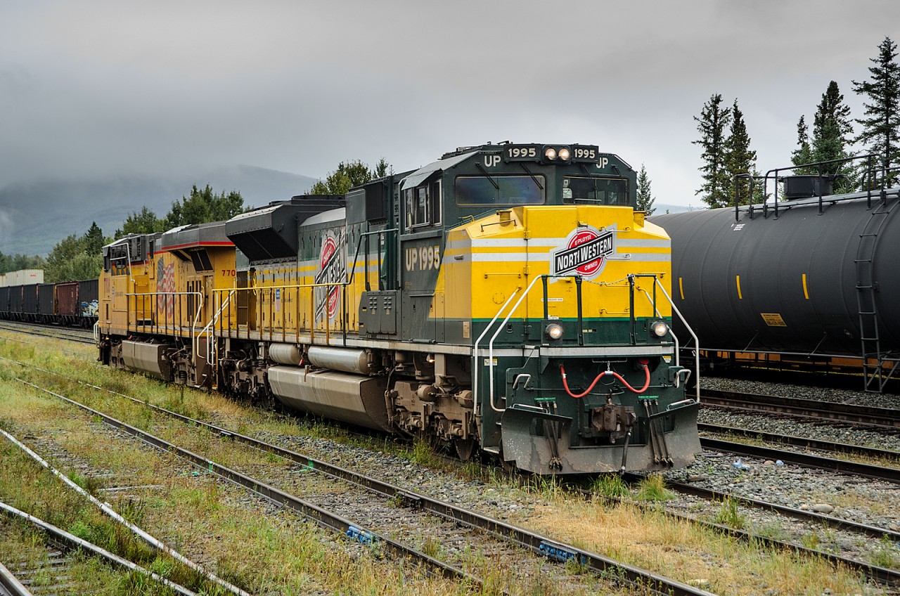 Wearing C&NW heritage colours, UP SD70ACe 1995 idles in the yard at Cheyenne, Wyoming - oops, wrong site!

Joking aside, it appears that UP is paying off some Horsepower Hours to CN in the form of about 8-10 high horsepowered units. For whatever reason, CN has decided to send them to the Grande Cache/Grande Prairie Subs between Swan Landing and Grande Prairie/Rycroft, AB. I love that out of all of the locomotives that UP owns, they decided to send a heritage unit. Here we see SD70ACe 1995 and ES44AC 7708 in the yard at Swan Landing waiting to be picked up by train A458 and taken north.