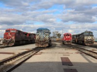 A variety of parked locos on the east end of the shop including a pair of NS C44-9W models.
