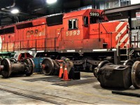 SD40-2 5993 in loco plant #2 with it's rear truck on the wheel lathe.On the right are EMD DC traction motors while the others to the left are GE AC motors.