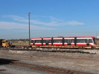 New Bombardier streetcar TTC 4583 ready for delivery while a Titan track mobile awaits a work assignment.