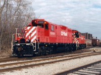The afternoon Galt Job with CP GP7u 1501 and SW1200RS 8161 have just set-off cars at the interchange (South Junction) with CN in Kitchener, Ontario. The units are slowly approaching the Hayward Avenue crossing and will soon reverse and head to the opposite end of the interchange where they will lift any cars that CN had left for them, before returning back to Galt on the Waterloo Subdivision. 
