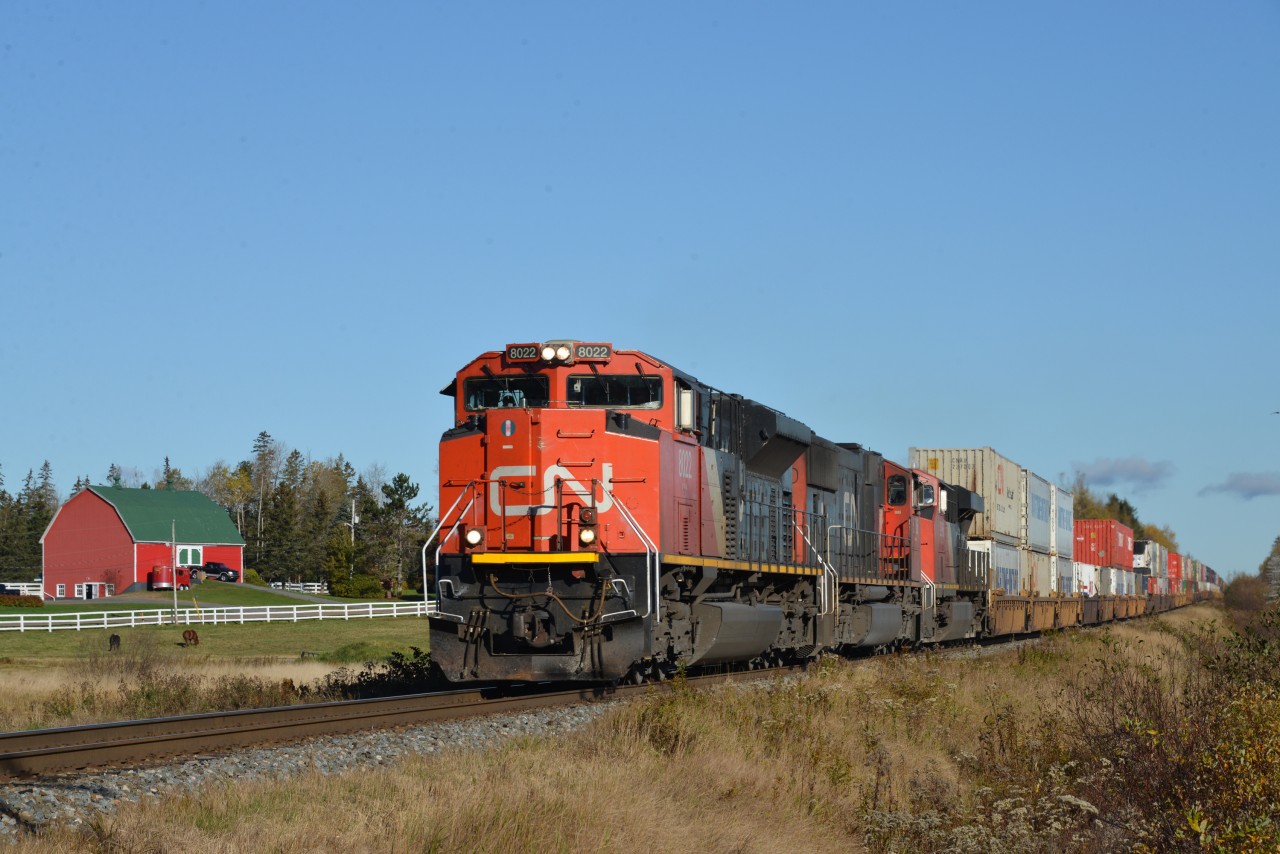 Train 120 is approaching the John Bell Road just to the north of Brookfield, Mileage 56.0  The power includes SD70M-2 8022 (GMDD 2007), 5706 2996 and DPU 8928.  At Brookfield, the stive active 2.8-mile Canada Cement Spur diverges to the west.