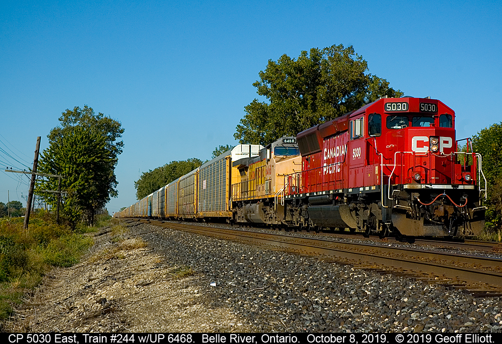 "Back Yard Basics"....  A simple shot of CP 5030 east, leading a tattered Union Pacific AC44CW #6468, as it rolls into the siding in Belle River, Ontario to meet westbound train #235.  CP 5030 is passing my backyard in this shot, and with the light being as good as it was I felt it was worth the walk over to grab this shot.  After waiting about 5 minutes for 235 to clear, and then for 244 to depart, I headed back to my patio to finish my coffee....  :-)