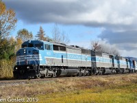 With consequtively numbered Blue Barns and a leaser, CMQ #1 tows 77 cars west toward Farnham QC along the Sherbrooke sub.