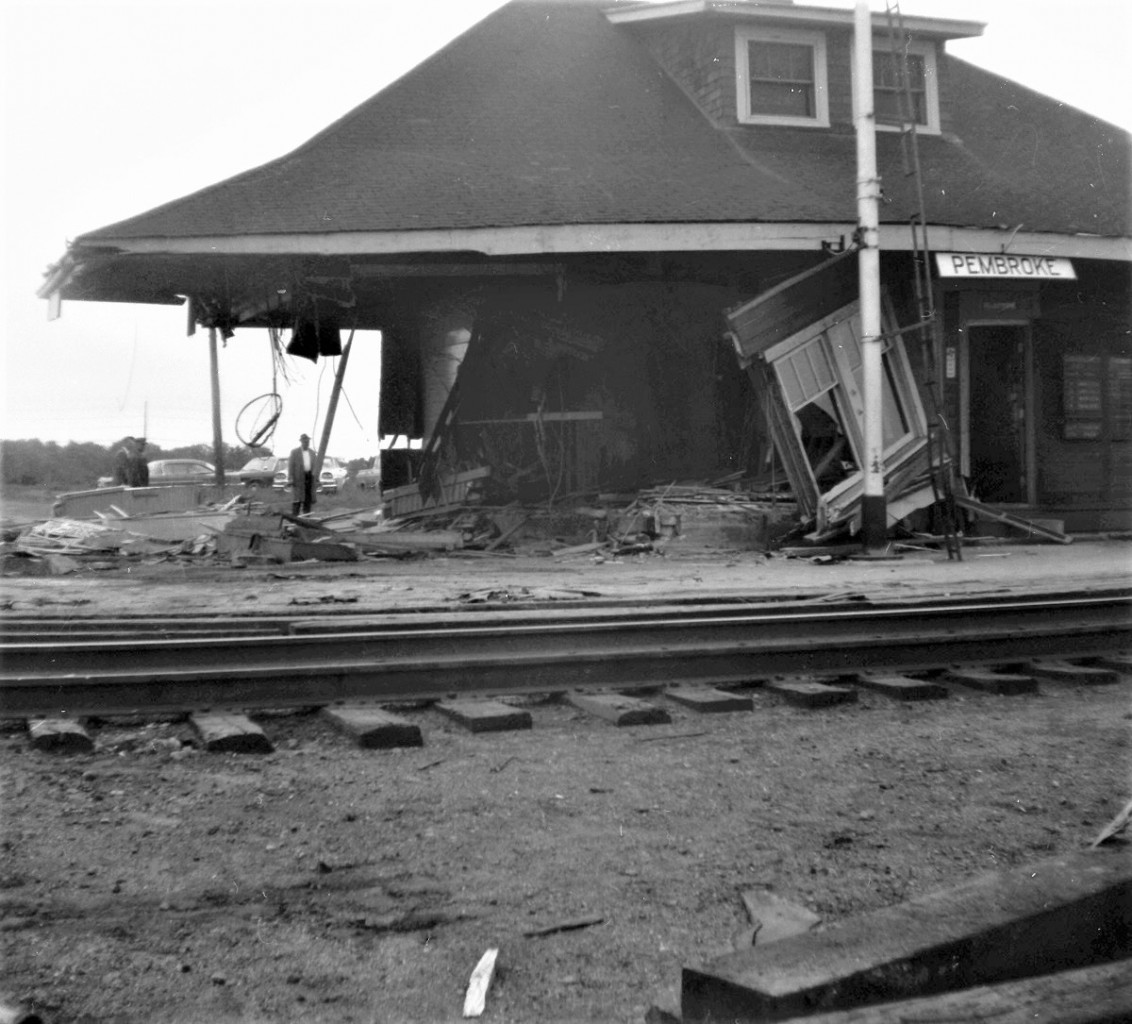 On the morning of Tuesday, August 31st, 1965, after westbound freight 401 passed, crews went to work to erase the old wood frame CN Pembroke Ontario station from the planet. This photograph shows the entire west side of the building missing.  It won't be long now.  As the entire structure was deemed as scrap, no effort was made to save anything. The process took only about a hour. Location is approximate.