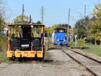 This fine Friday morning in Brampton actually finds a CPR maintenance machine resting on the long-disused Brampton siding just past the switch to the main as the bi-weekly short line freight is seen approaching on the main just before the switch with GMTX 333 in the lead. Time is 11:28 and if you note how only the rails of the siding are visible in front of the machine (the rest covered in dirt) it was only this past August when the city I believe more or less buried the rusty siding up to the double-tracked Nelson st crossing, well single-tracked now as the siding rails in the road were also resonantly patched over and from what I have heard, the siding will likely be removed sometime next spring but it’s only rumor so who knows what’ll happen. It’ll be a interesting wait for sure! Siding sure dose have some history behind it! 