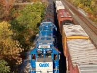 A CN local has just cleared the late day shadows cast by the Lemonville bridge as it frantically pushes cars back into the yard and out of train 393’s way, seen holding the main. Lead unit 2284 has long since given up its days of hauling commuters for the Long Island Railroad. The plated over bug eye marker light housings are a dead giveaway of the units heritage.