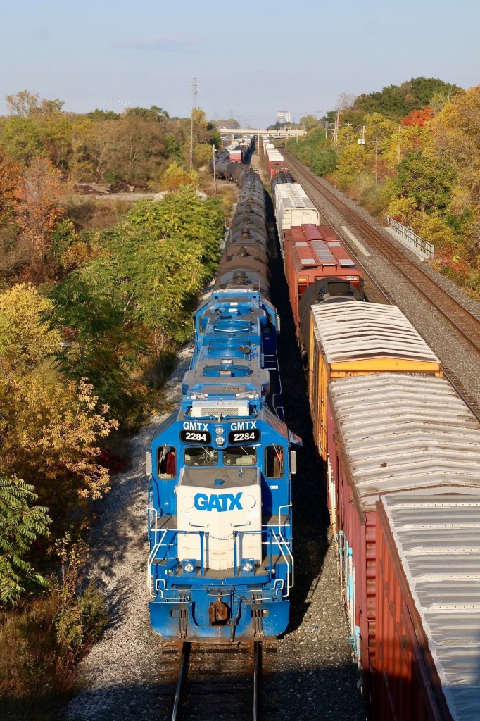A CN local has just cleared the late day shadows cast by the Lemonville bridge as it frantically pushes cars back into the yard and out of train 393’s way, seen holding the main. Lead unit 2284 has long since given up its days of hauling commuters for the Long Island Railroad. The plated over bug eye marker light housings are a dead giveaway of the units heritage.