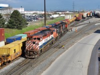 After having just finished hauling a intermodel freight into CN’s Brampton Intermodel Yard and spotting it on one of the holding tracks, BCOL 4620 is seen slowly creeping out of the holding tracks in the yard towards the Queen st overpass (where I was standing) with a pair of CN sd75Is, 5759 and 5693 trailing. They have officially finished today’s work and will now run light power towards the south end of BIT where they will likely be re-assigned to a outbound train sometime soon with a new crew. Time is 17:24. <br> Also note the number patch on the right hand side of 4620. Looks like the railway must have used spray paint as a temporary fix after the original fell off. It happens, especially if a locomotive has a lot of birthday’s behind it! 