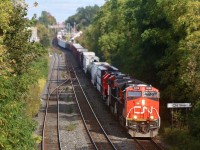The lead unit on CN train 399 quickly catches the suns rays in a break in the trees at Silver (Georgetown). Within a couple of weeks the trees foliage won’t be an issue anymore, which will greatly reduce the tree shadows. The entire consist today is in relatively fresh paint including the pair of former GTW GP38’s trailing the lead units. The closest track is the Guelph Subdivision with its switches lined for a GO Train arriving soon out of Kitchener.